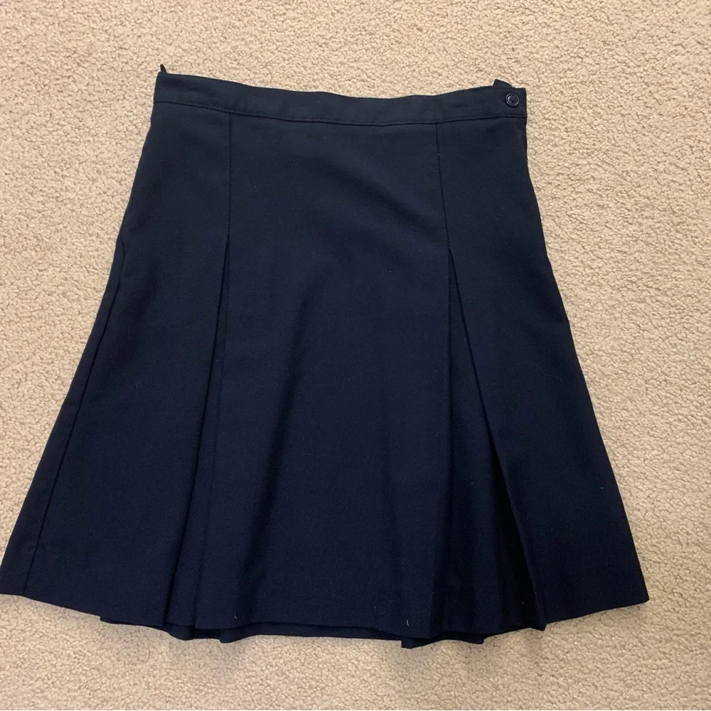 Navy blue pleated skirt with adjustable waist.